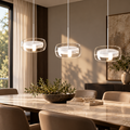 White LED disc pendants installed over a contemporary dining table