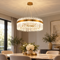 Gold crystal pendant chandelier installed in a refined dining room