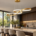 Gold sculptural LED pendant installed above a kitchen island