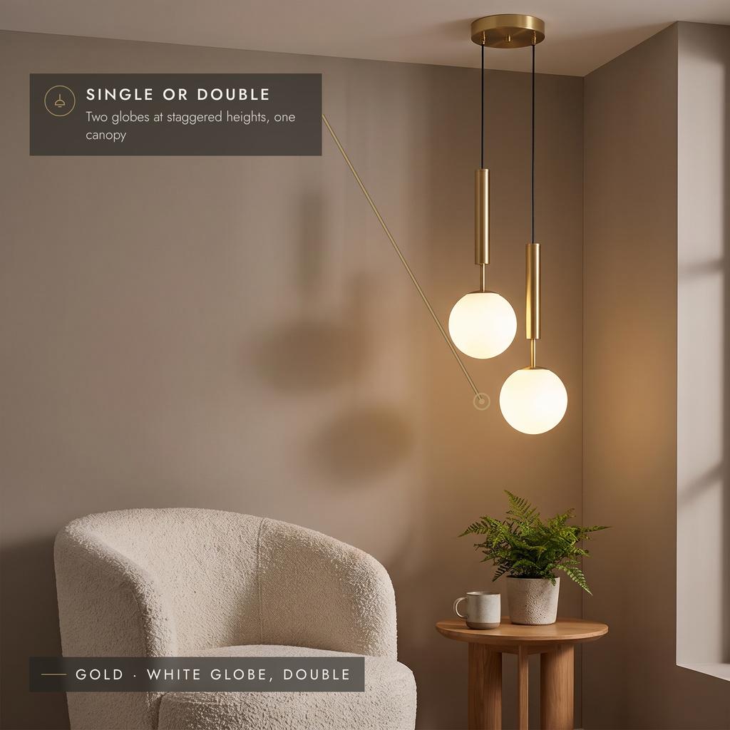 Gold double globe pendant with two white opal globes at staggered heights in a reading corner