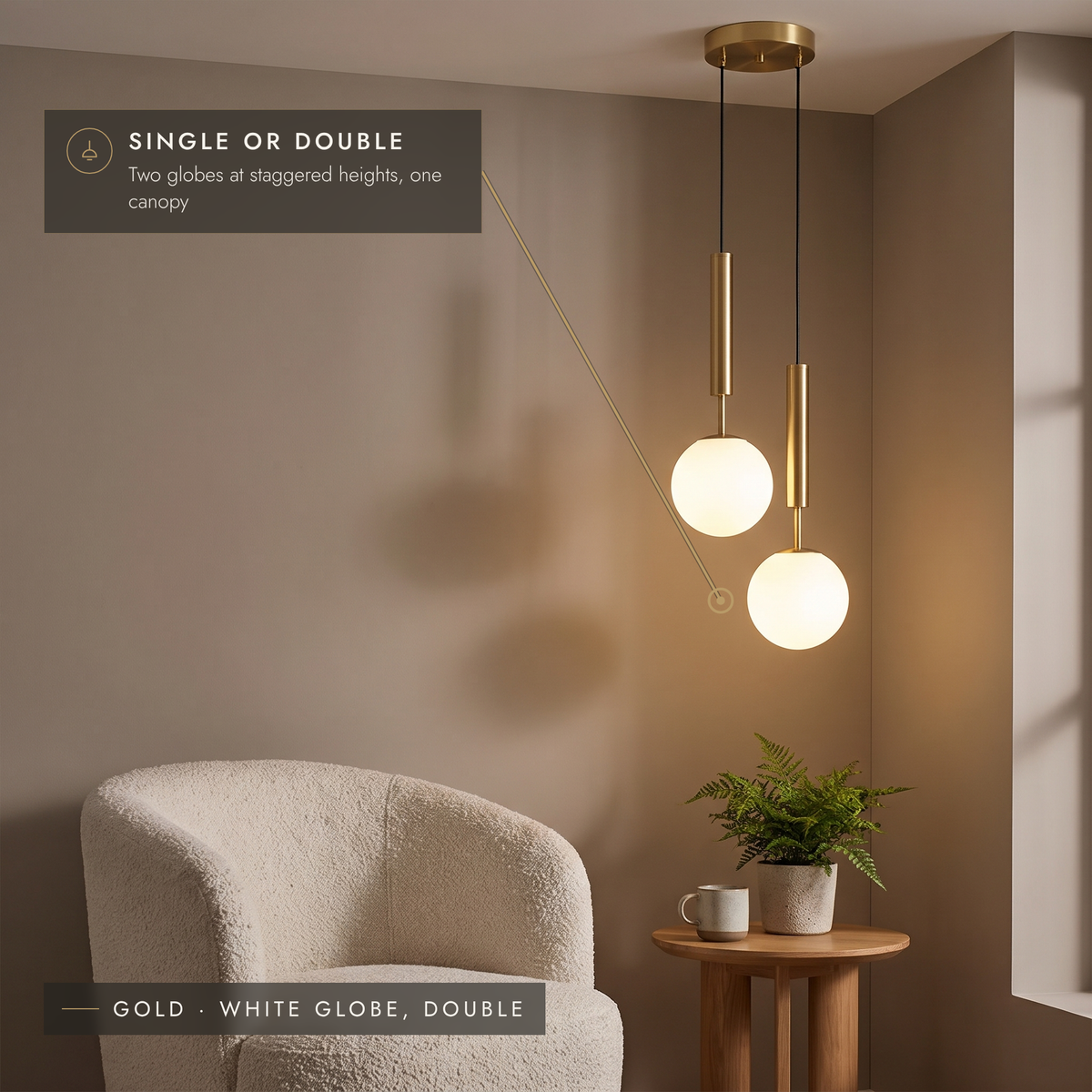 Gold double globe pendant with two white opal globes at staggered heights in a reading corner