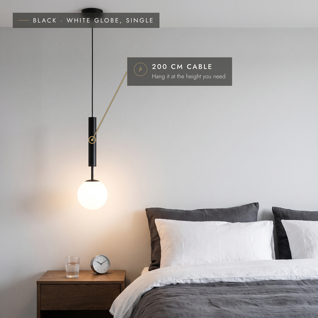 Black globe pendant light with white opal globe and 200 cm cable in a bedroom