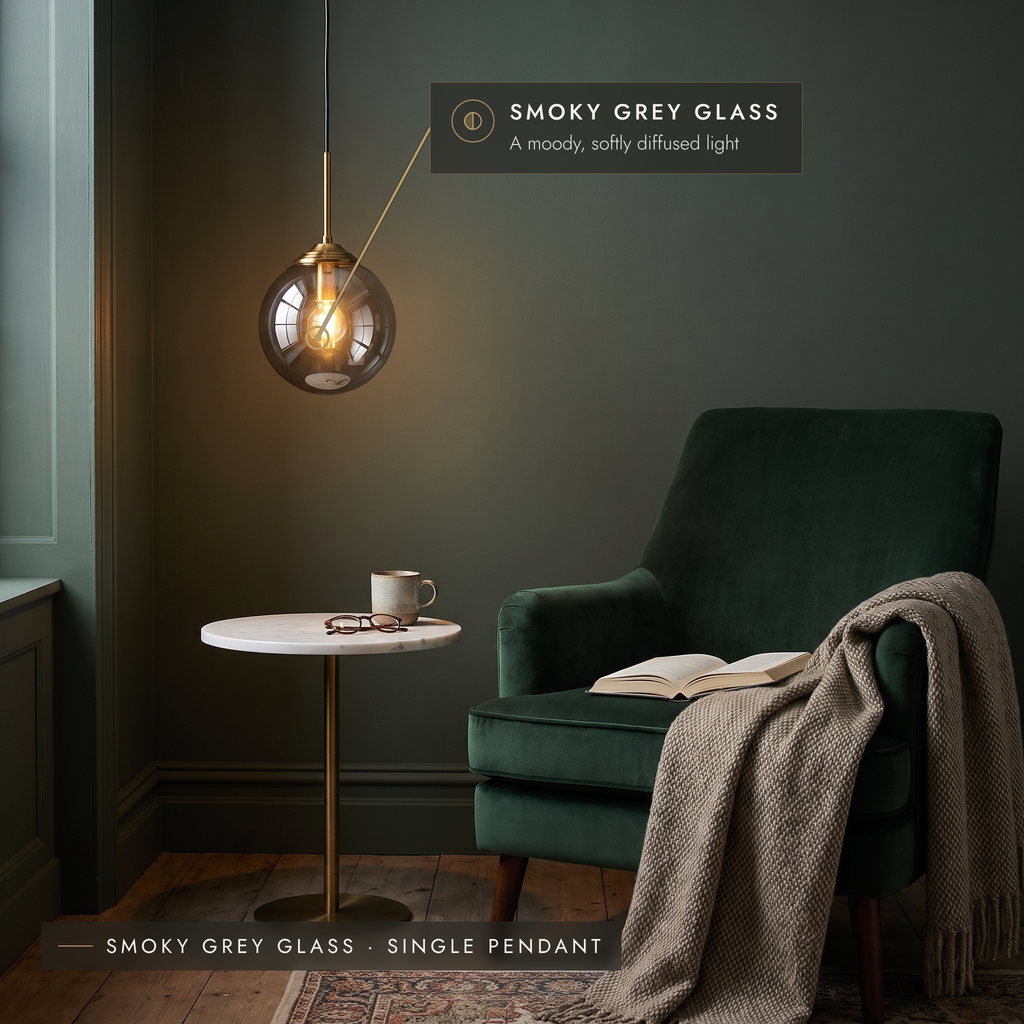 Smoky grey glass globe pendant light in a dark green reading nook