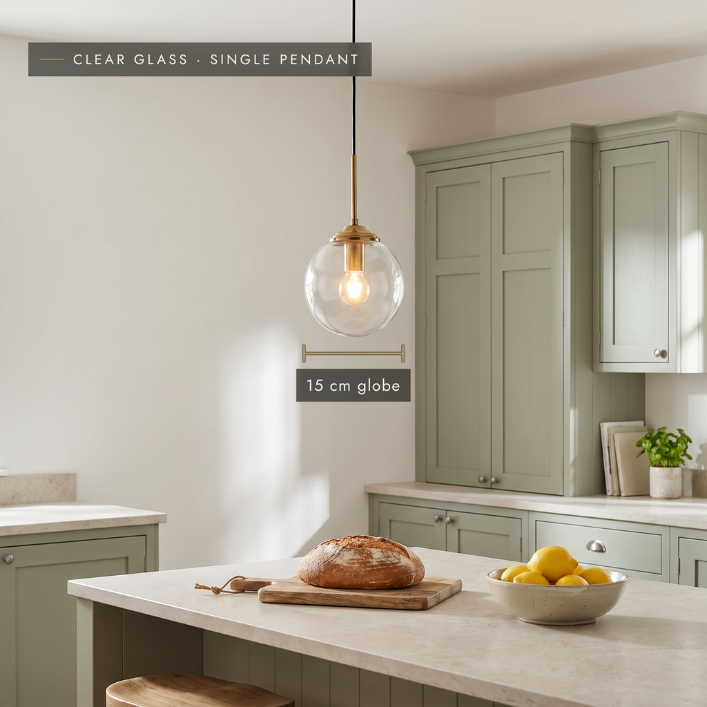 Clear glass globe pendant light, 15 cm, above a kitchen island