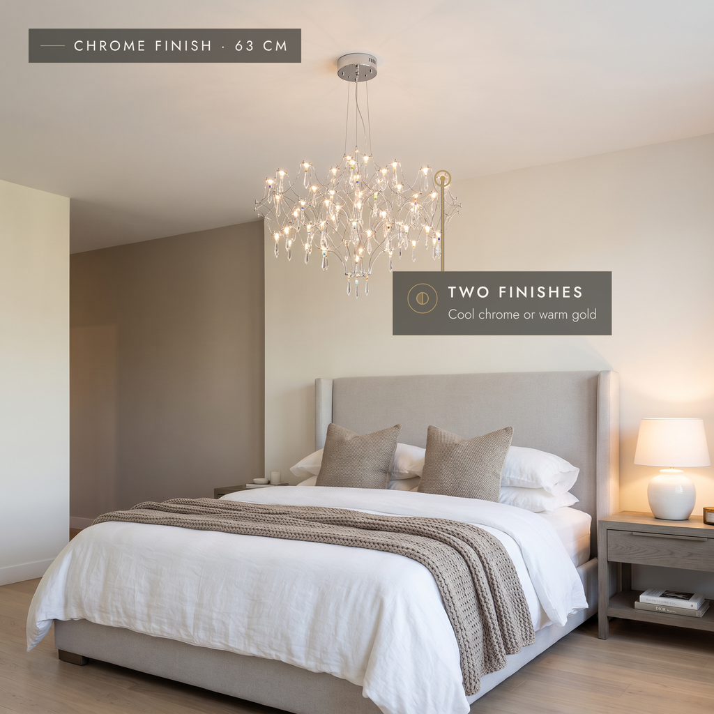 Chrome finish 63 cm crystal-effect LED pendant chandelier above a bed in a grey bedroom