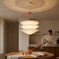 Layered paper pendant chandelier, 70 cm, glowing above a round oak dining table in a Japandi dining room