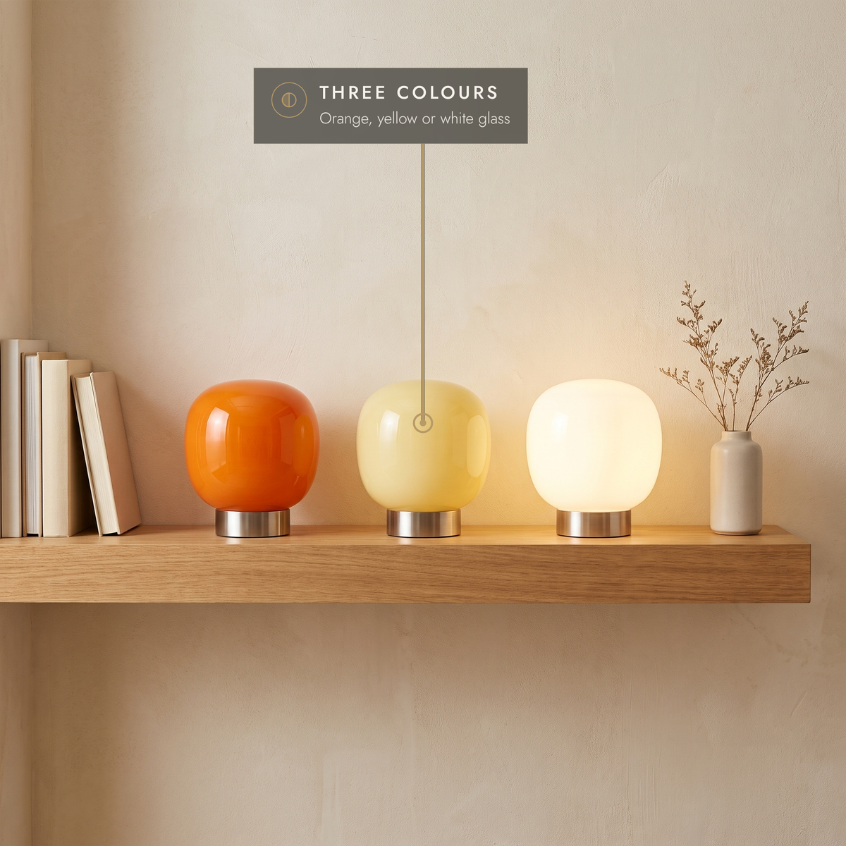 Glass globe table lamps in orange, yellow and white on an oak shelf