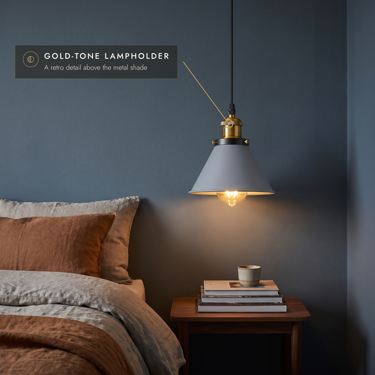 Grey cone pendant used as a bedside light against a blue-grey wall