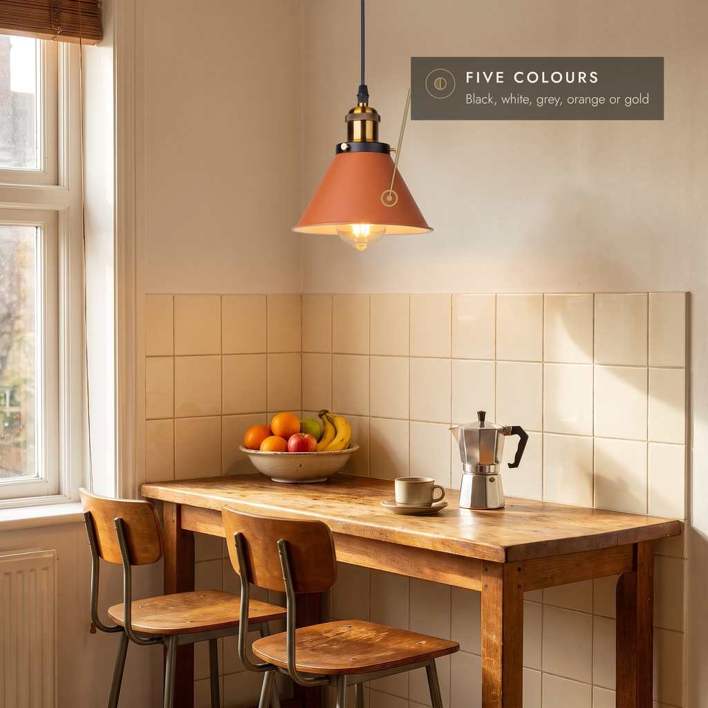 Orange cone pendant light above a wooden breakfast bar