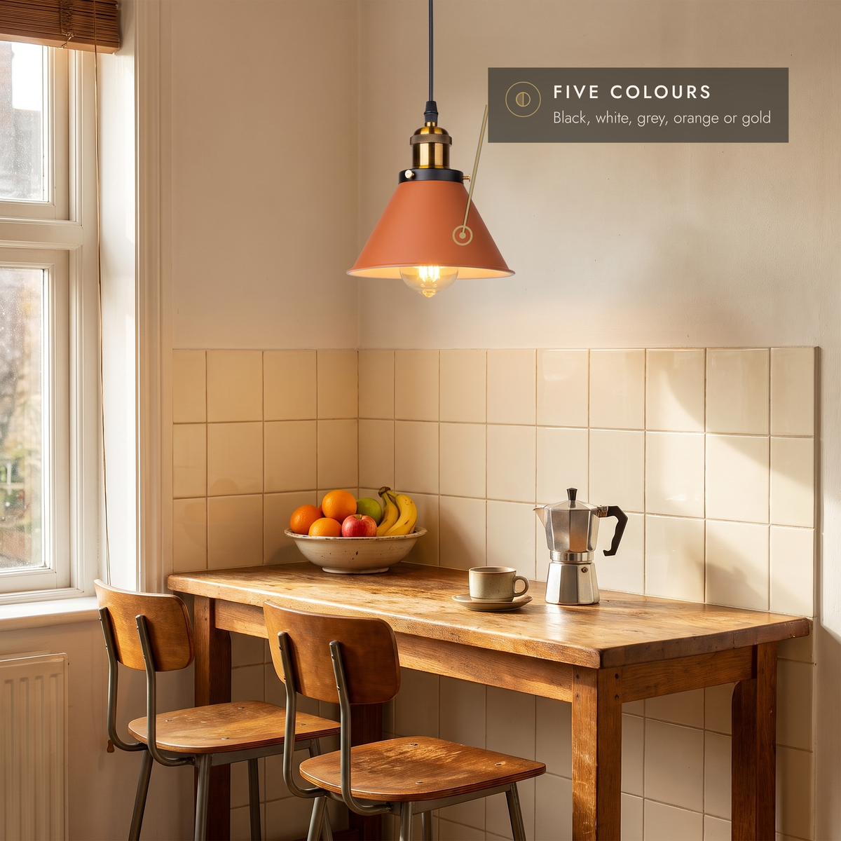 Orange cone pendant light above a wooden breakfast bar