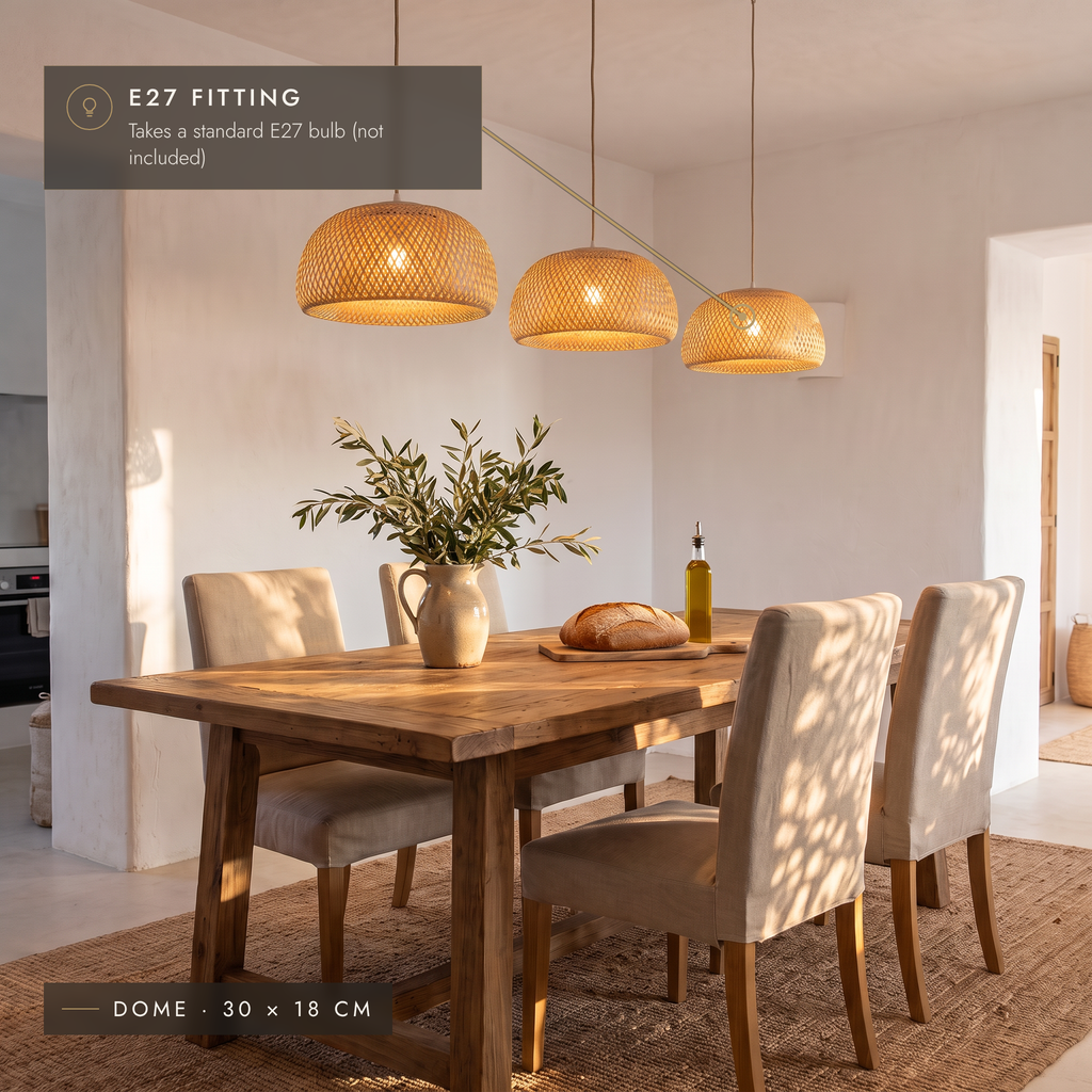 Three bamboo dome pendant lights above a rustic wooden dining table
