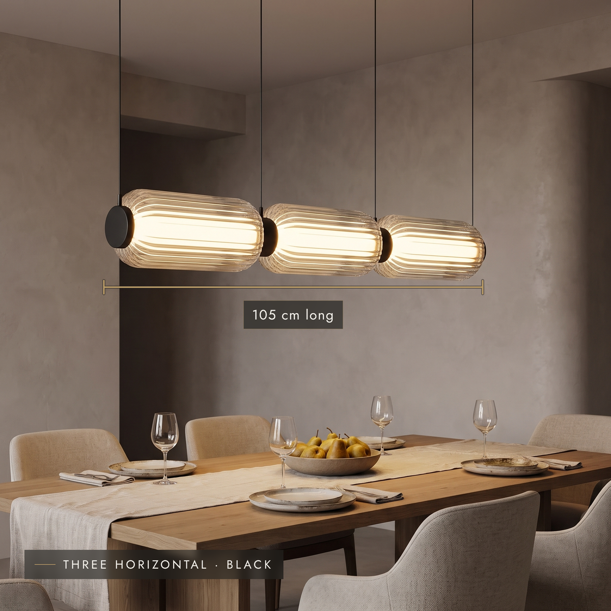 Horizontal three-cylinder ribbed LED pendant above an oak dining table
