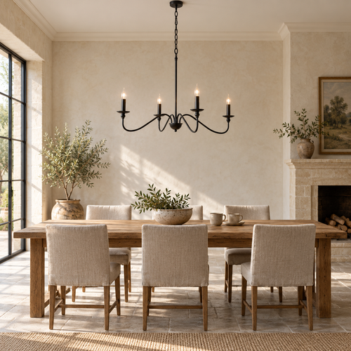 Black four-light curved-arm chandelier above an oak dining table.